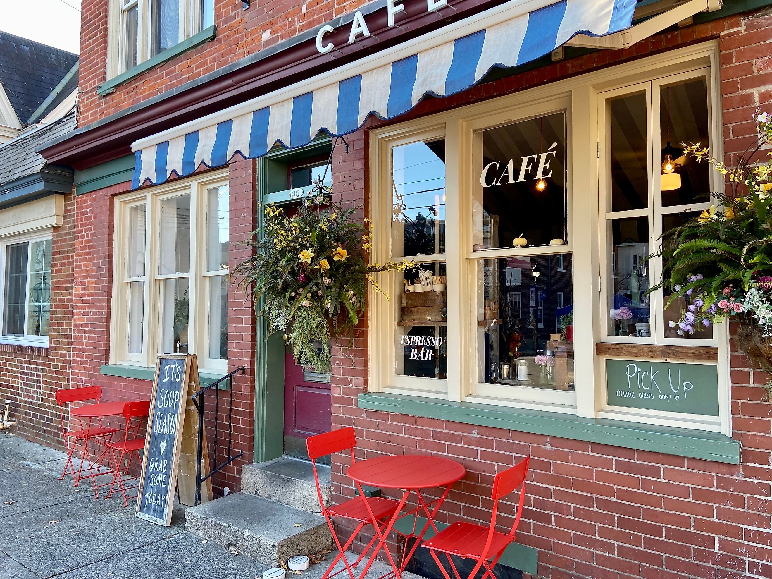 Cafe with a striped awning and red tables and chairs in downtown Stroudsburg, Pennsylvania. Editorial credit: Here Now / Shutterstock.com