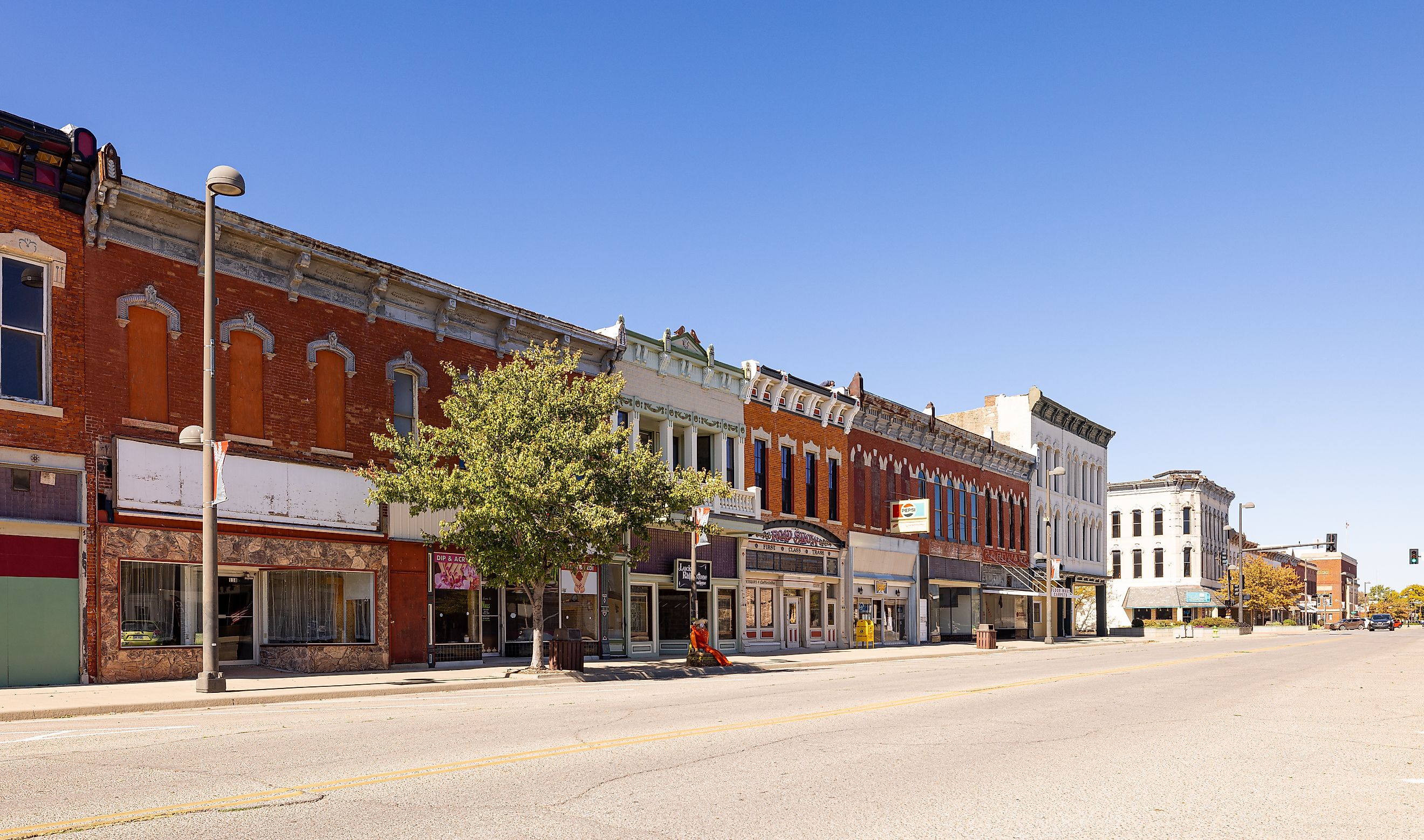 Rustic buildings along a street in Wellington, Kansas old business district. Editorial credit: Roberto Galan / Shutterstock.com