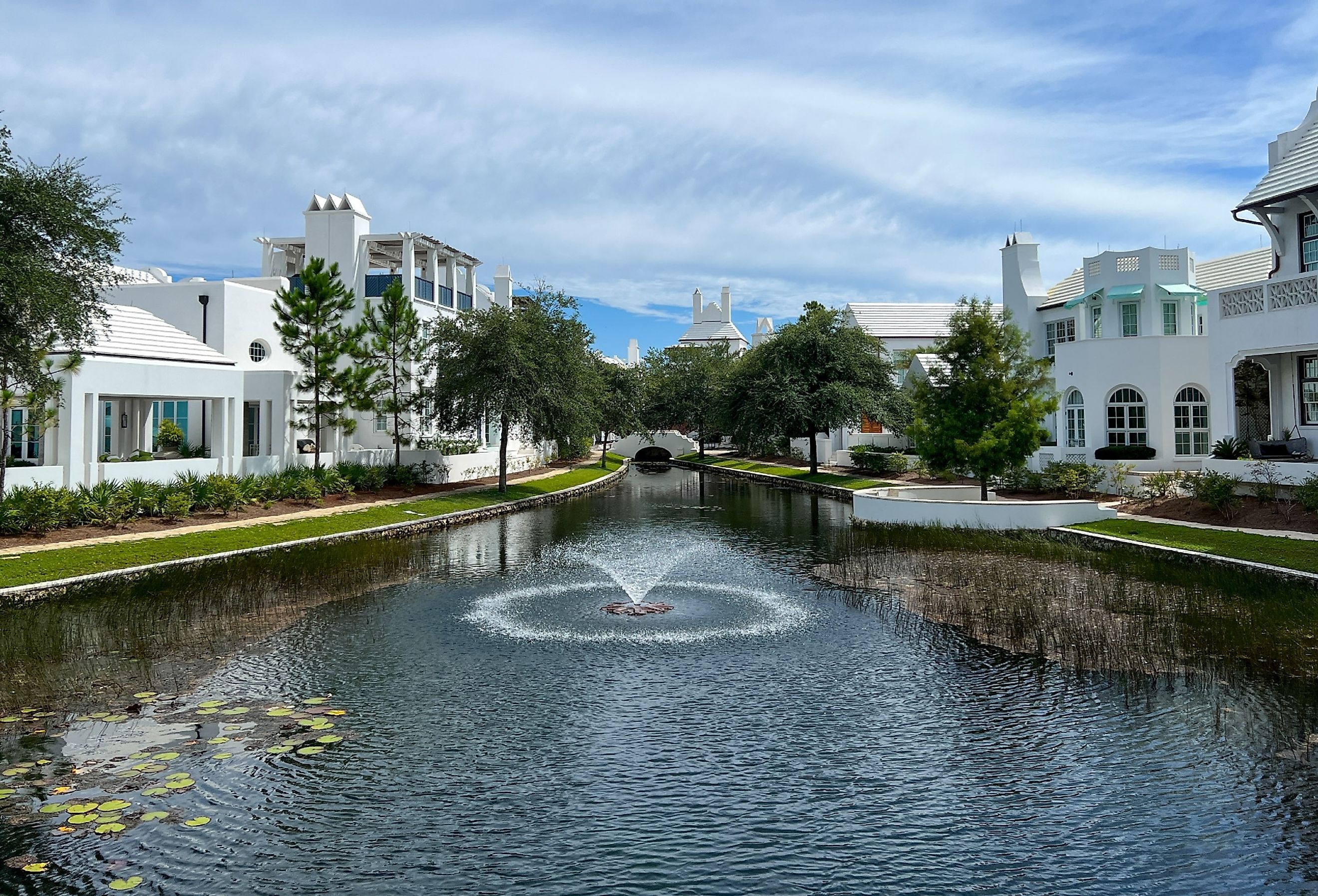 A walking path with water features and homes in Alys Beach, Florida. Image credit Joni Hanebutt via Shutterstock
