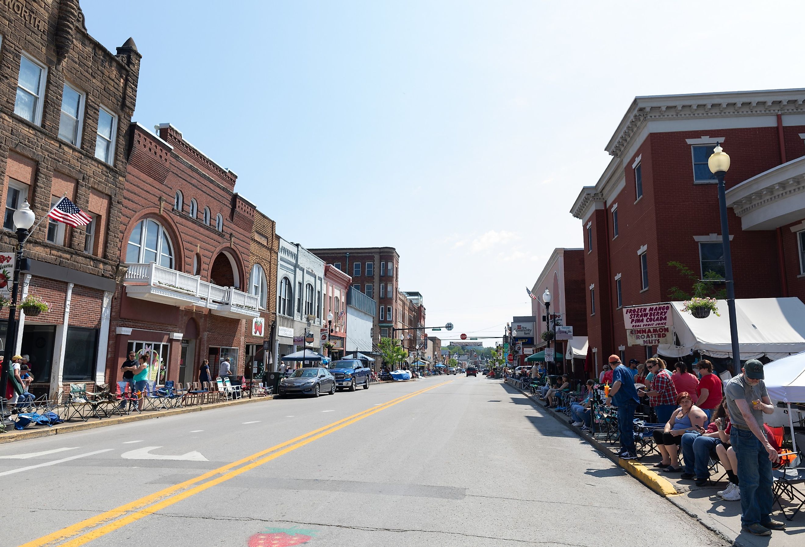 Historic buildings along Main Street, with locals and tourist walking along, waiting for the parade in Buckhannon, West Virginia. Image credit Roberto Galan via Shutterstock