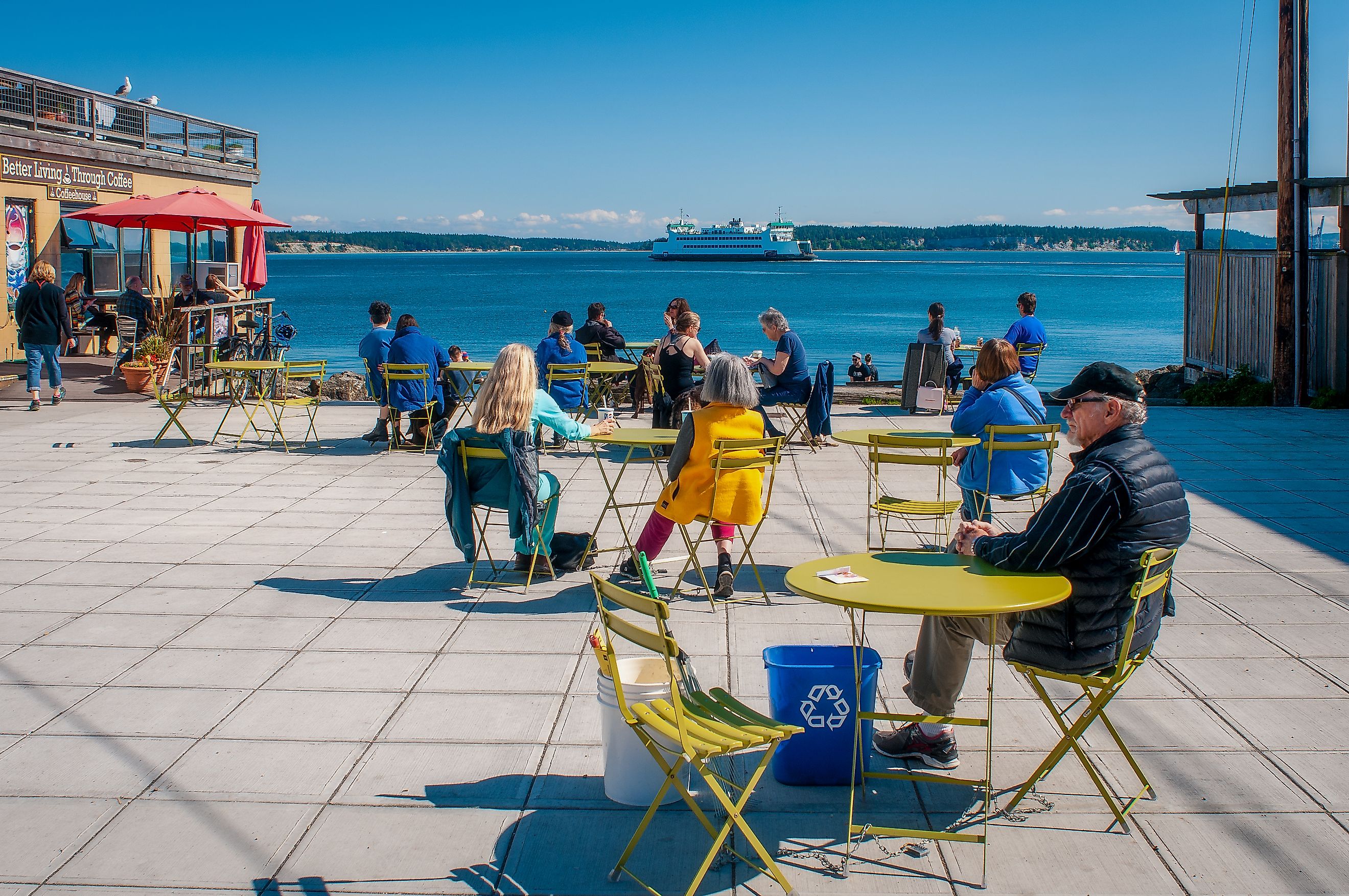 Washington State ferry Kennewick steams out of Port Townsend past Main Street Plaza, where people enjoy a sunny day, Port Townsend, Washington, US. Editorial credit: Gareth Janzen / Shutterstock.com