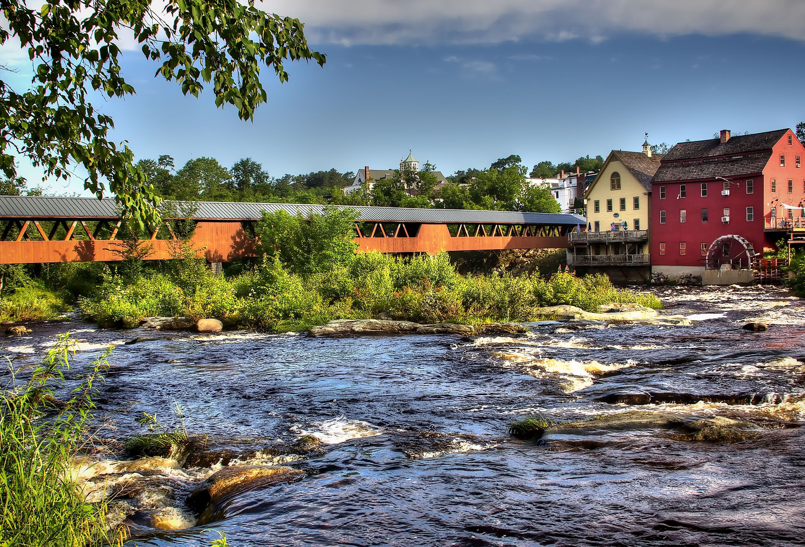 The River Walk overed bridge with the Grist Mill on the Ammonoosuc River in Littleton, New Hampshire.