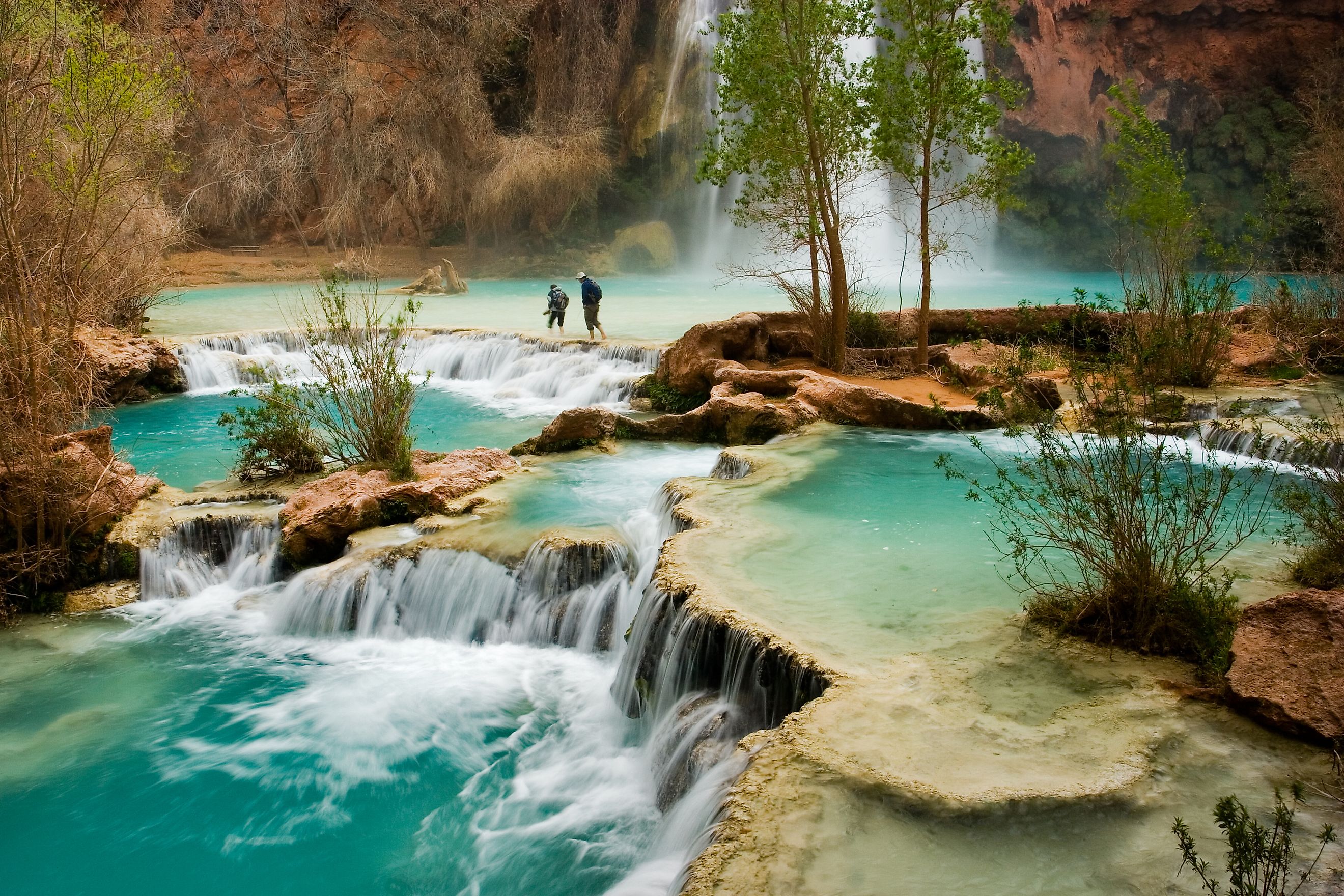 Hikers at the beautiful Havasu Falls in Arizona.