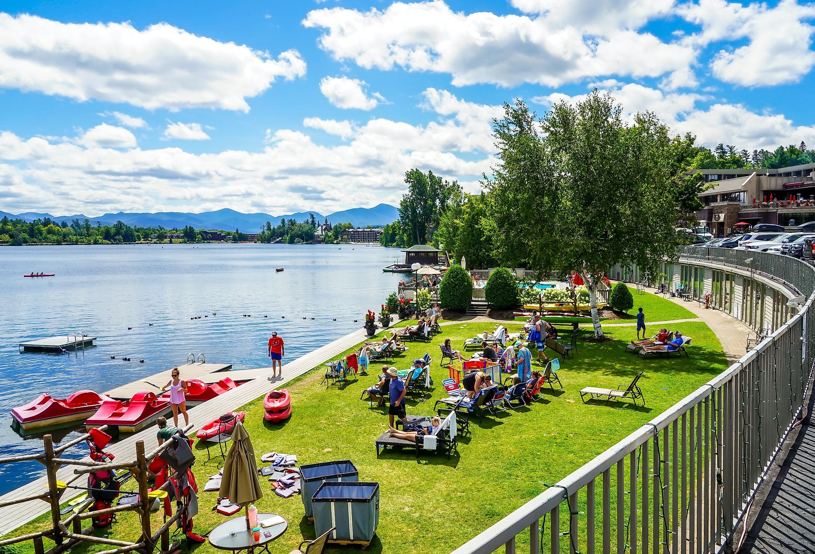 Beach at Mirror Lake in Lake Placid, upstate New York, with tourists and boat rentals. Image credit Leonard Zhukovsky via Shutterstock.