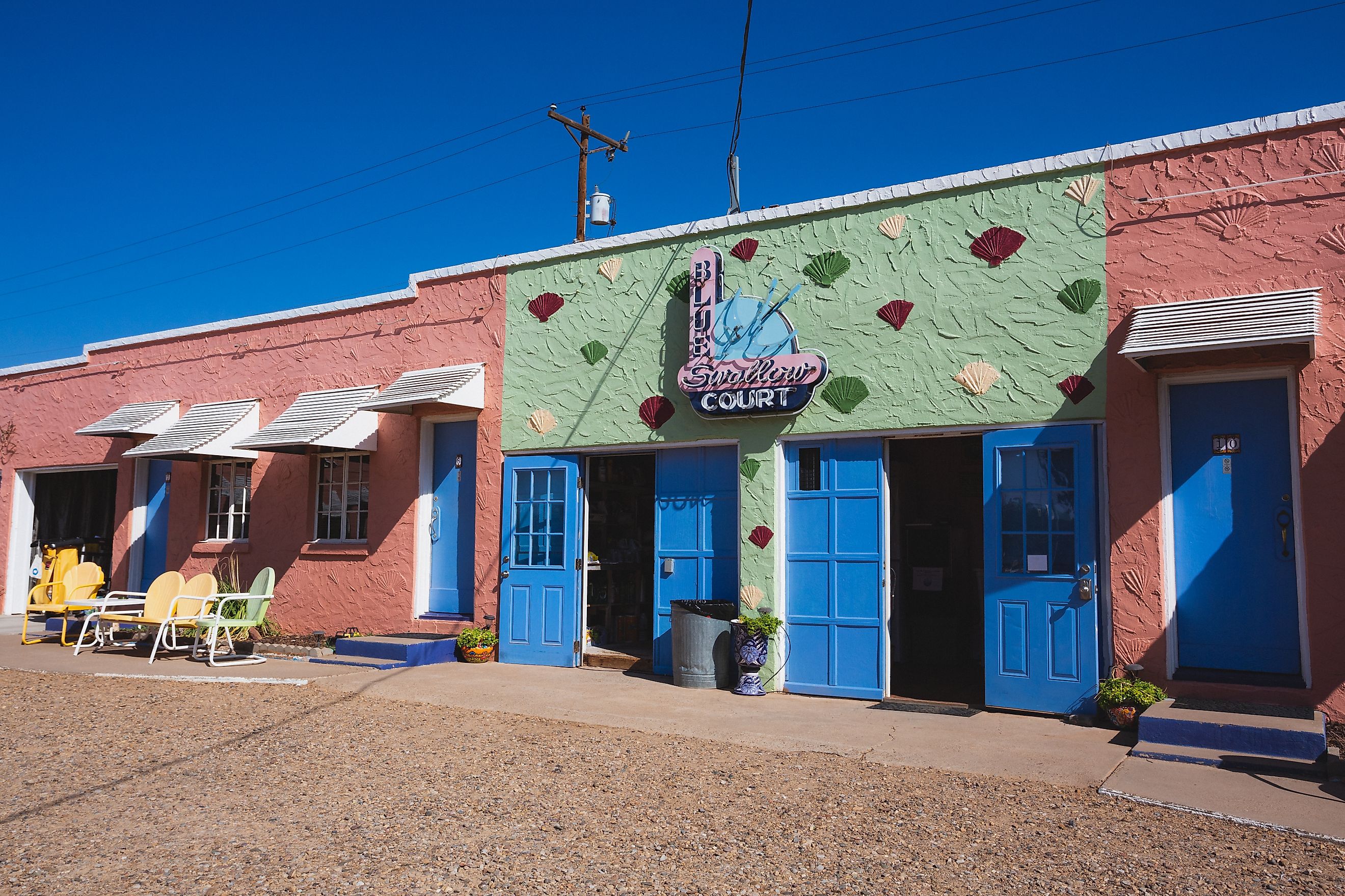 Tucumcari, New Mexico - September 6, 2020: Sunlight at the laundry room and neon signs at the historic Blue Swallow Motel on Route 66. Editorial credit: Logan Bush / Shutterstock.com