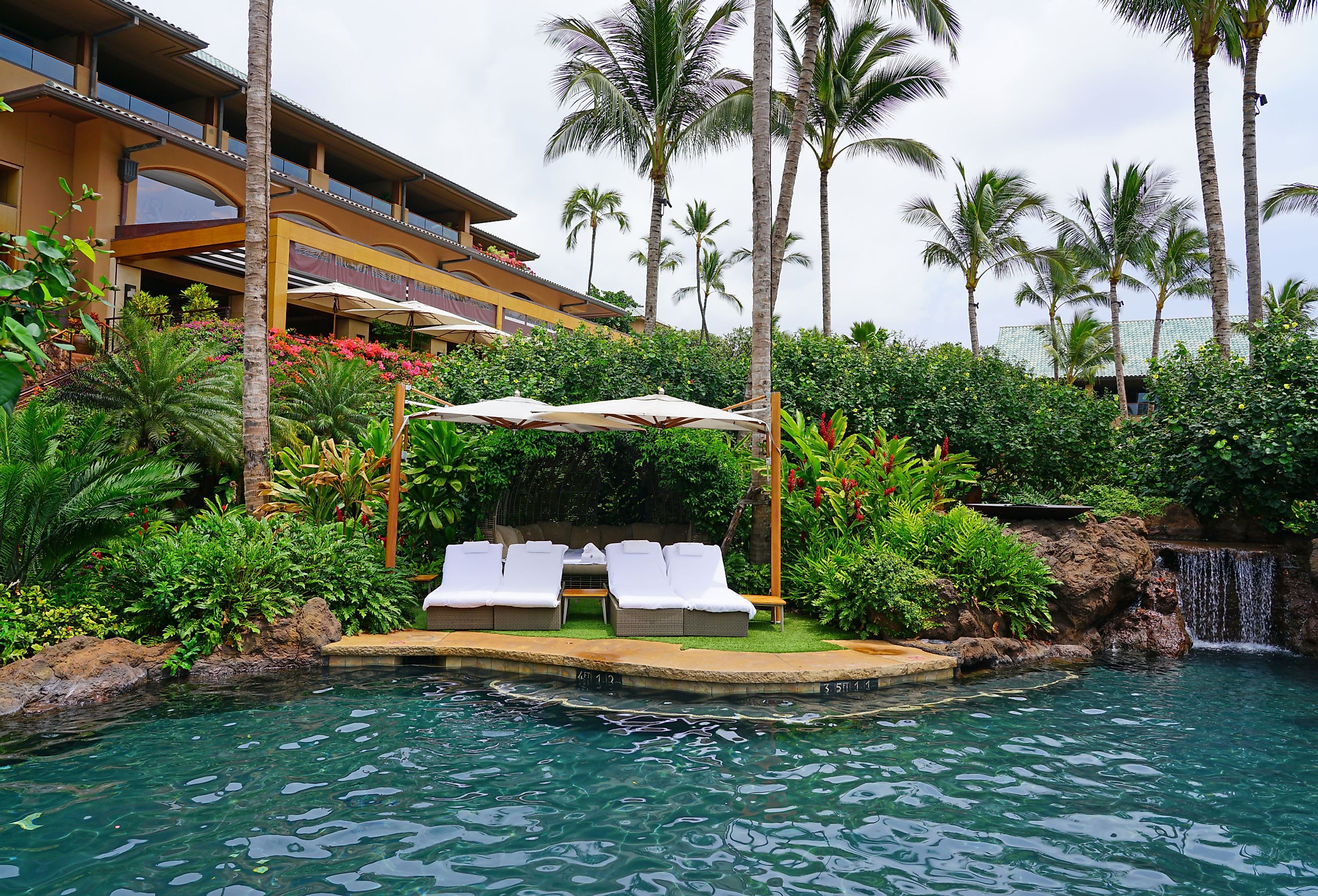 View of the Four Seasons Resort Lanai, an upscale luxury hotel next to Hulopoe Beach on the Pacific Ocean. Image credit EQRoy via Shutterstock.