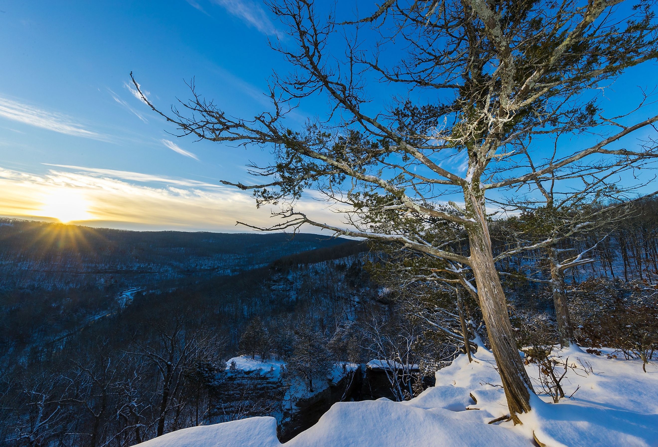 Early morning sunrise over a snowy Devils Den State park in Arkansas.