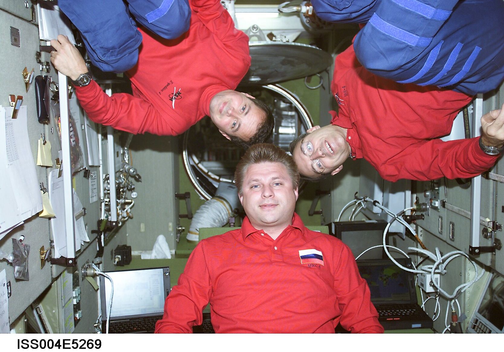 ISS004-E-5269 (December 2001) --- Cosmonaut Yuri I. Onufrienko, Expedition Four mission commander, flanked by astronauts Daniel W. Bursch (left) and Carl E. Walz, both flight engineers, pose for an informal crew photo in the Zvezda Service Module on the I