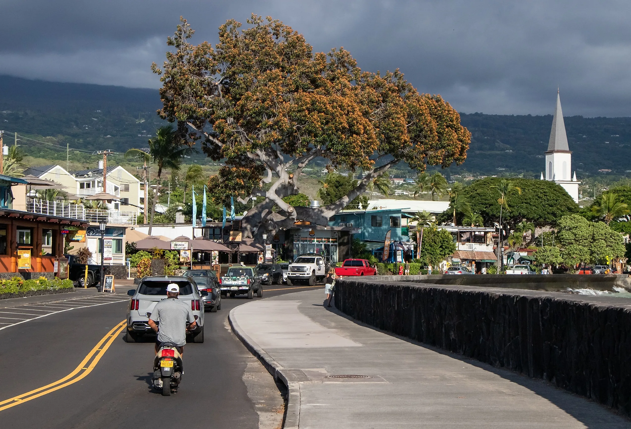 Busy street, shops, cafes, and seaside walkway in autumn in Kona, Hawaii.