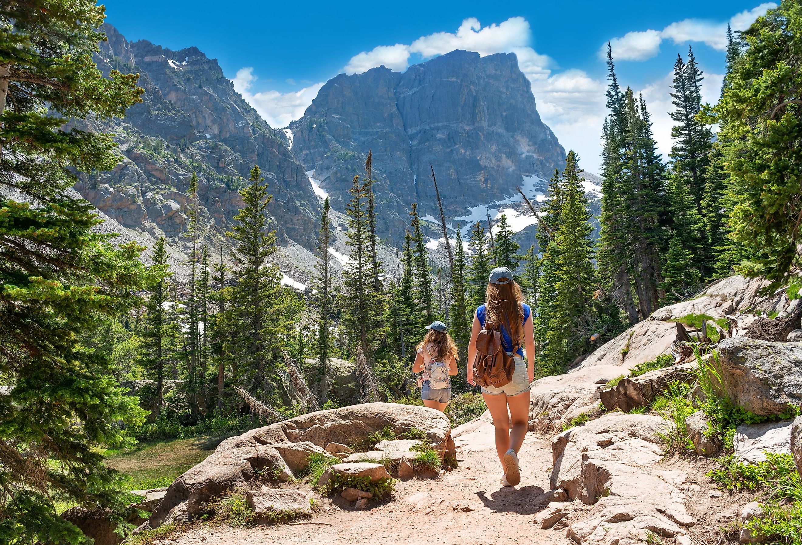 Girls on summer vacation hiking trip in the mountains, hiking on Emerald Lake Trail, Estes Park, Rocky Mountains National Park, Colorado.