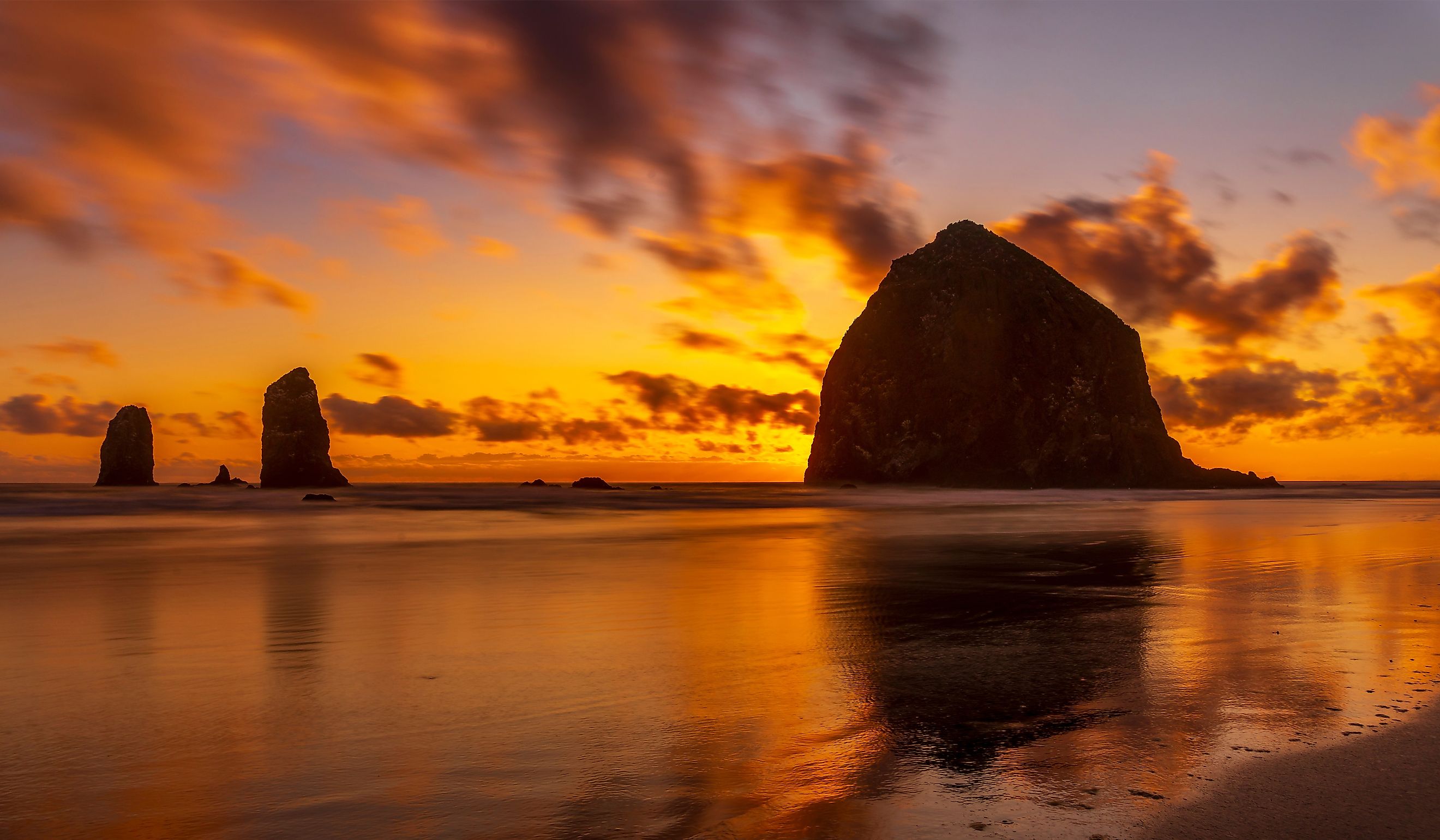 Sunset at Haystack Rock and The Needles at Cannon Beach, Oregon.