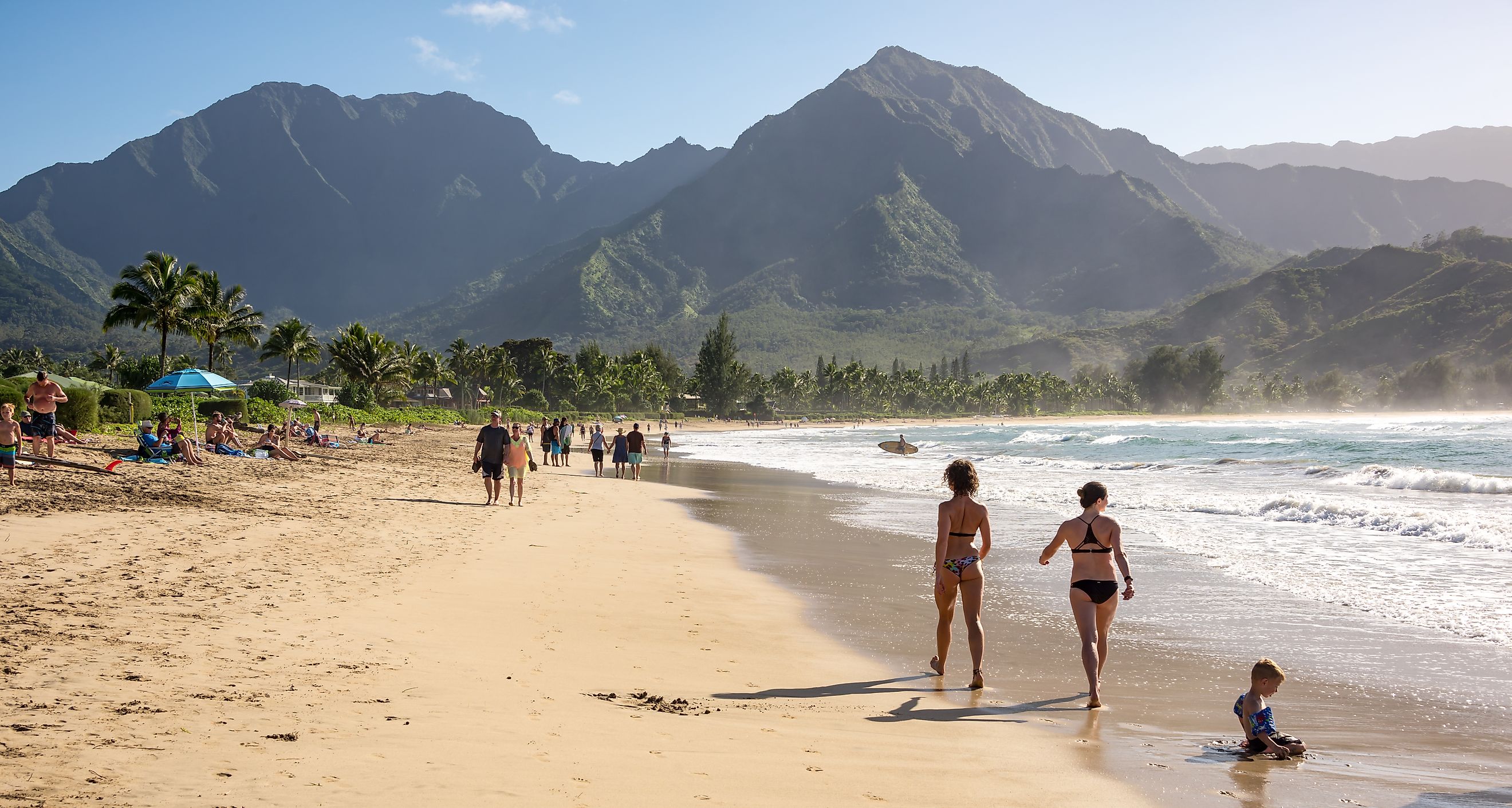 People enjoying the sun and views on the beach at Hanalei Bay on the north shore of Kauai, Hawaii. Editorial credit: Chase Clausen / Shutterstock.com