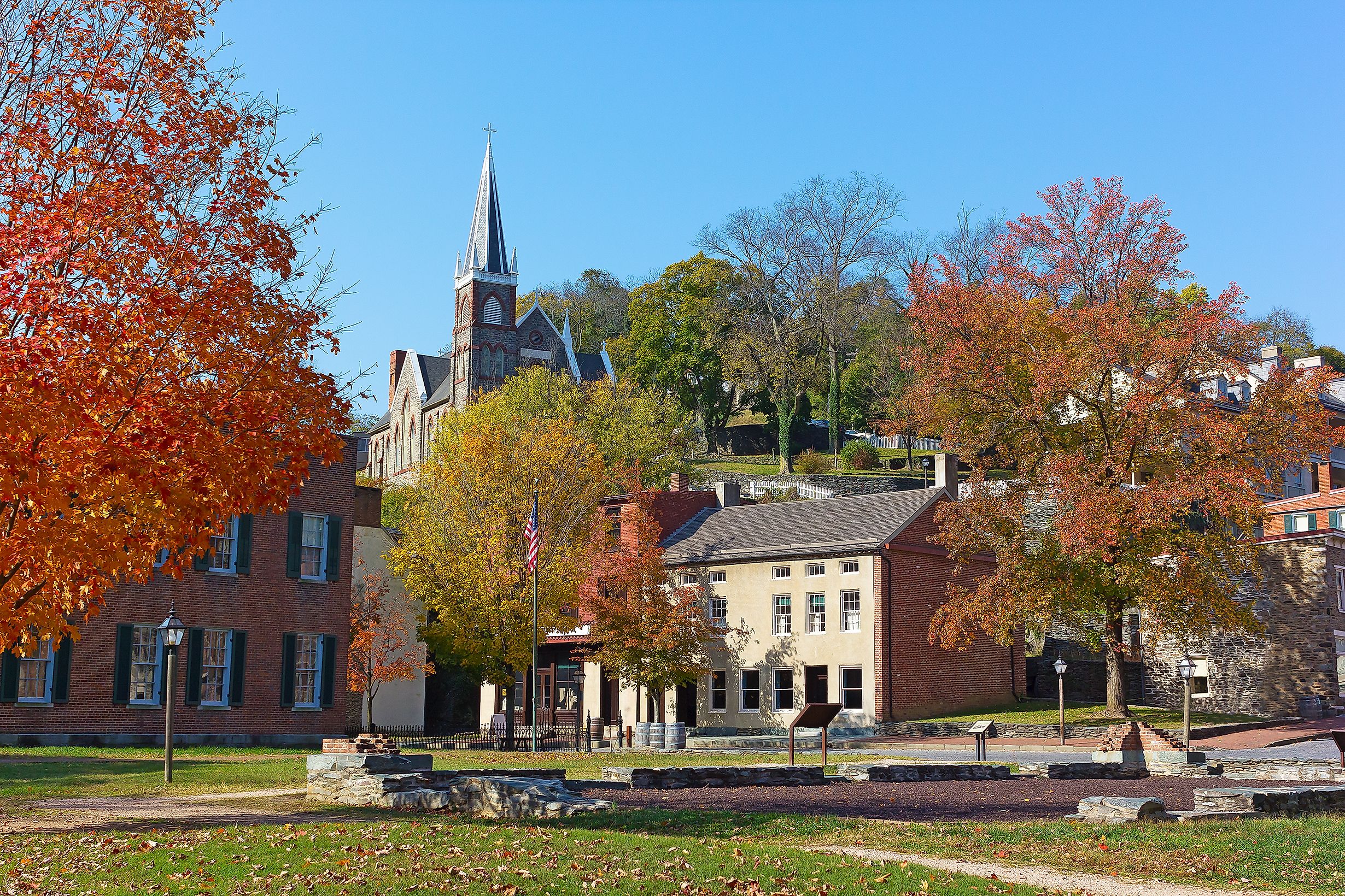 Harpers Ferry historic town in autumn, West Virginia, USA. St. Peter's Catholic Church and historic town buildings.