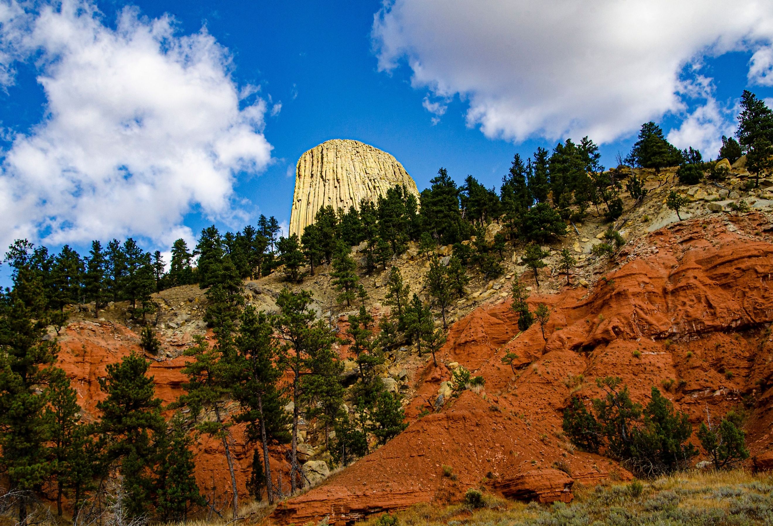 Sundance, Devil's Tower National Monument, Devil's Tower framed by colorful Red Bluff. 