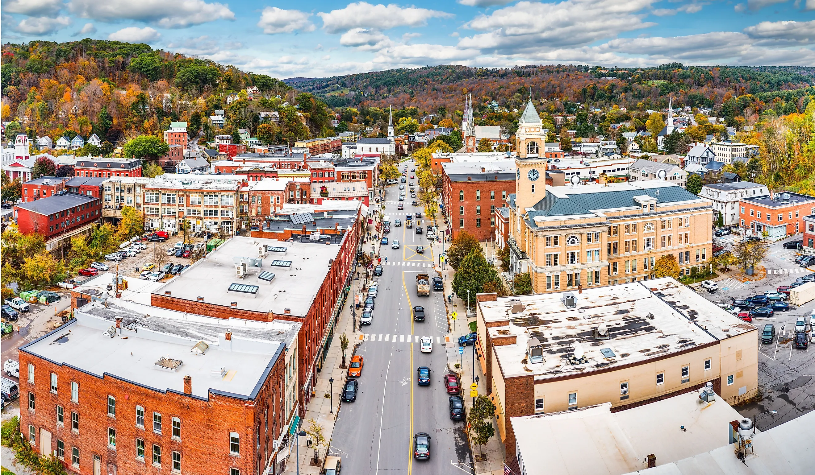 Aerial view of Montpelier, VT cityscape along Main Street on a sunny day with fall foliage colors.