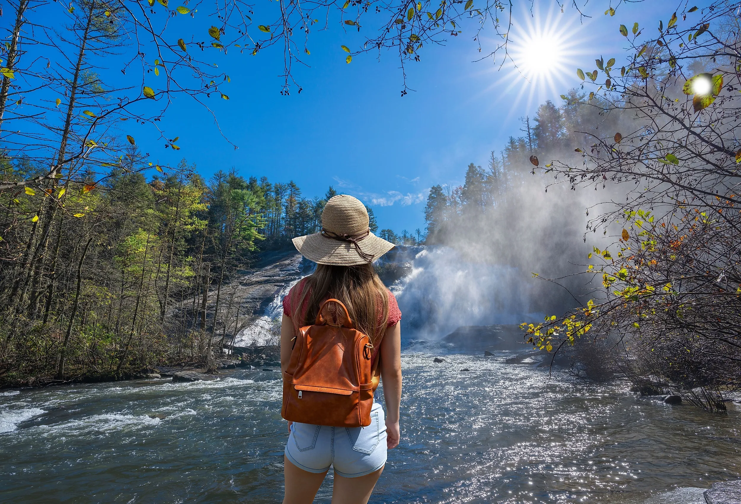 Woman hiker by the waterfall in Dupont State Forest in Brevard, NC.