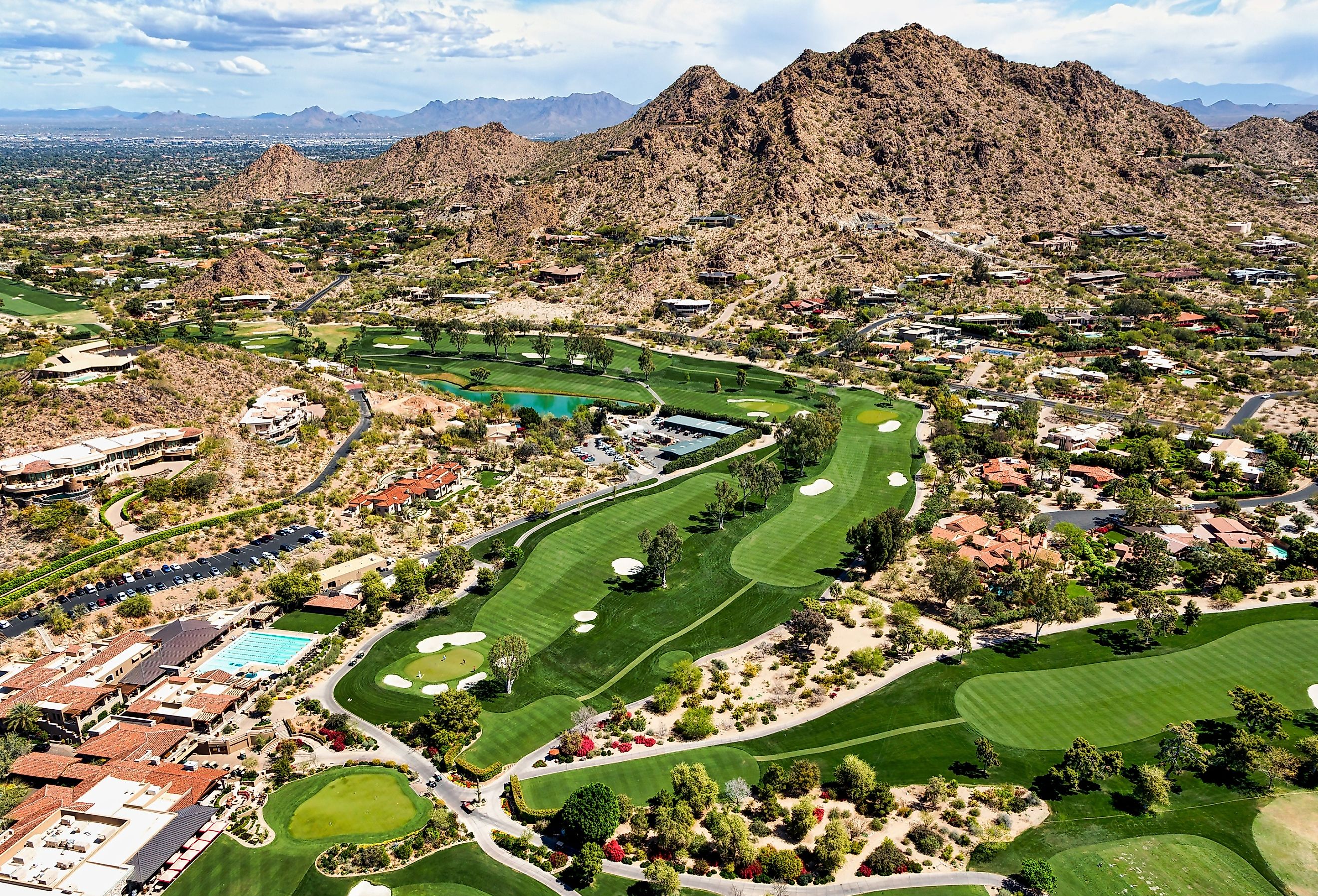 Aerial view from above a scenic golf course in Paradise Valley, Arizona looking to the northeast at Mummy Mountain and the McDowell Mountains in the distance