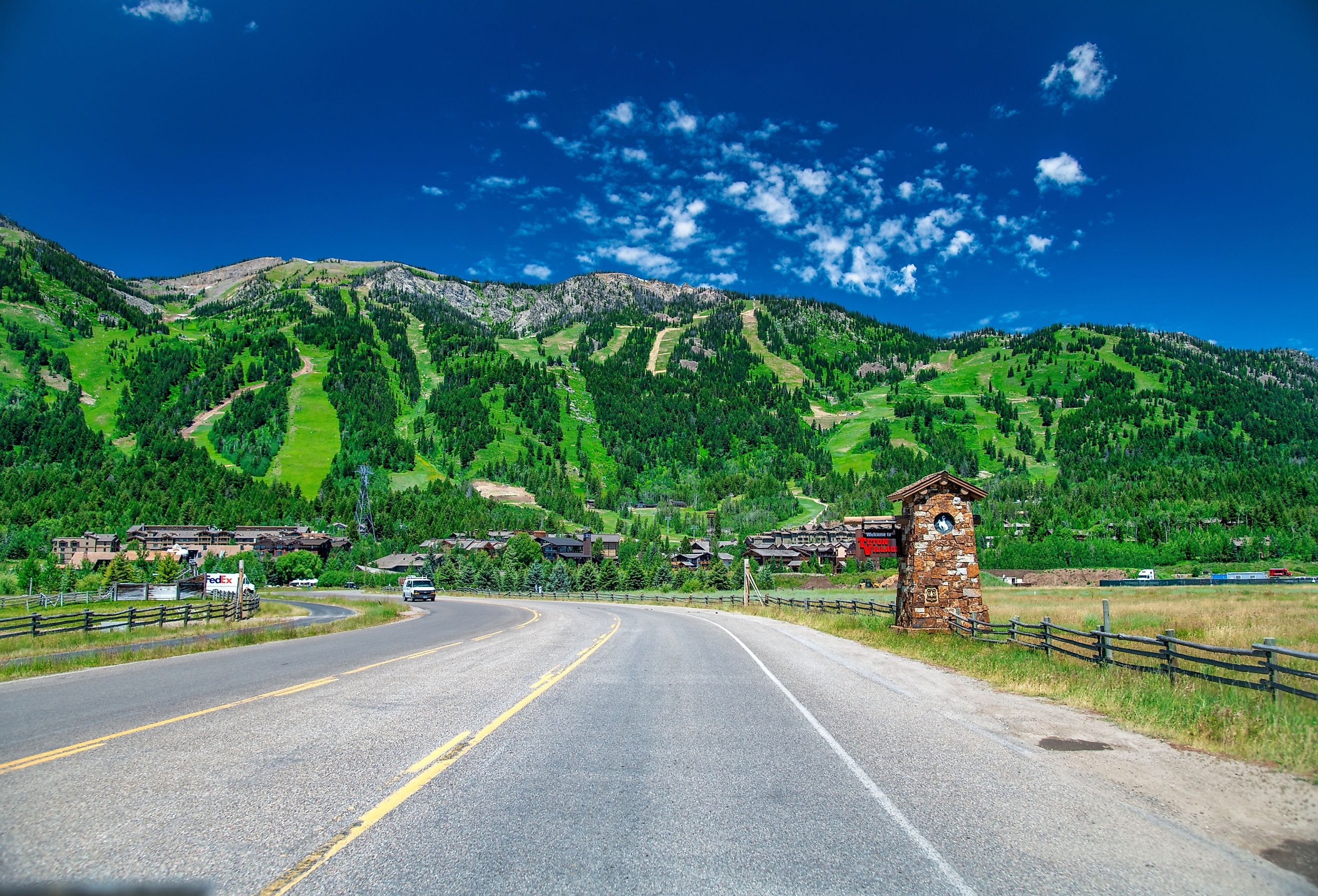 Amazing view of Jackson Village with road and mountains in summer season, Wyoming.