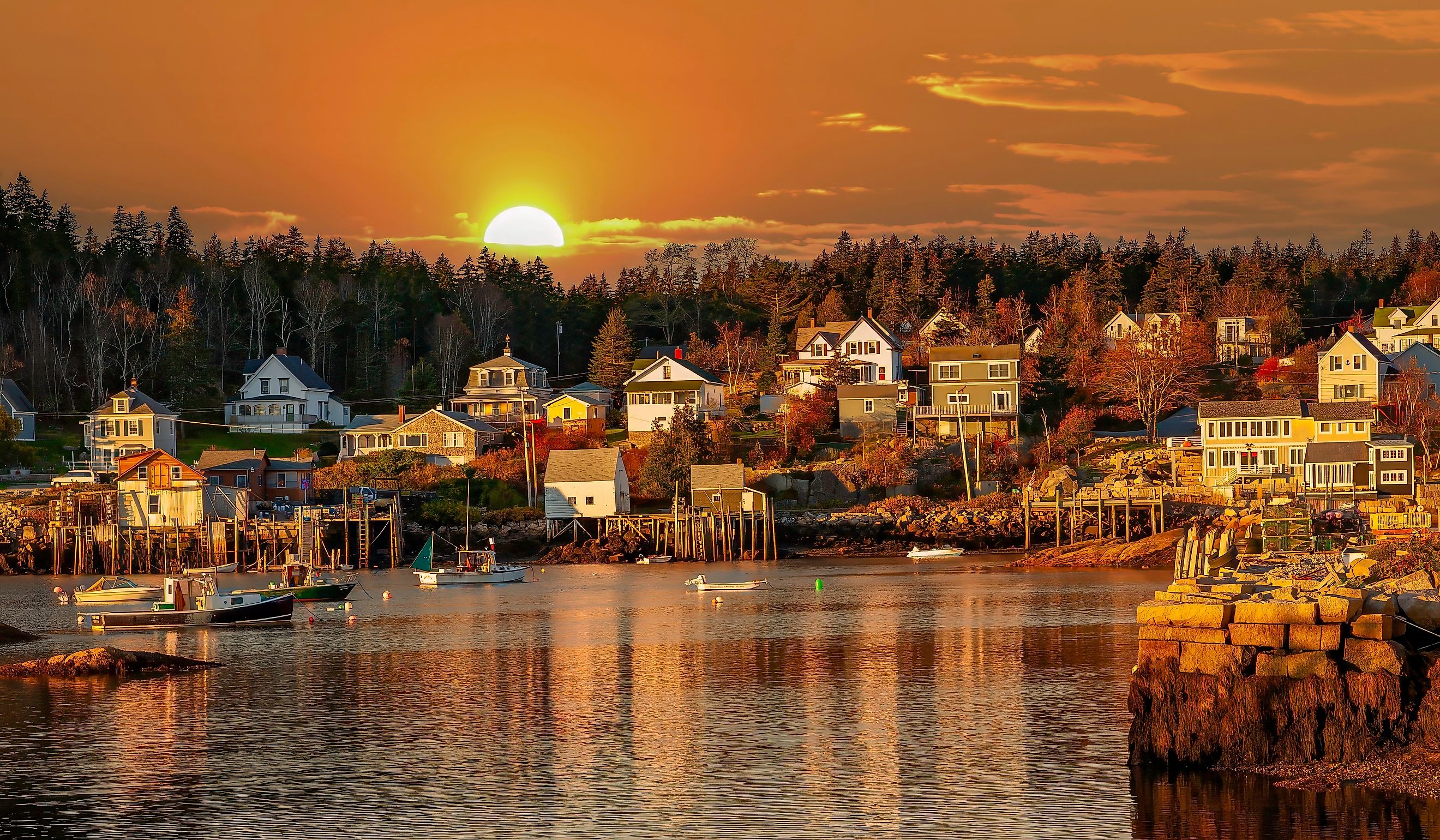 Lobster boats at anchor and bay front homes, Stonington, Maine. 